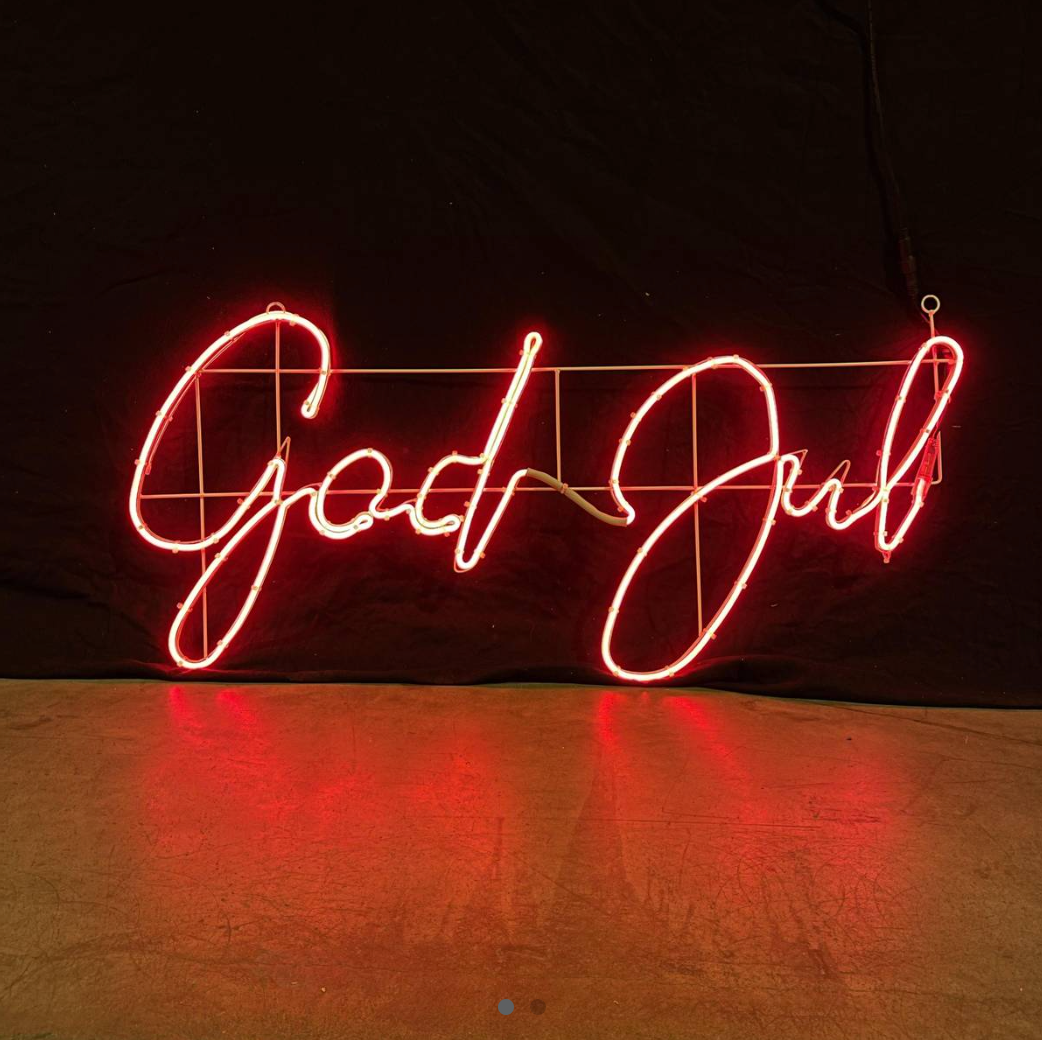 Red neon sign with the Christmas greeting God Jul