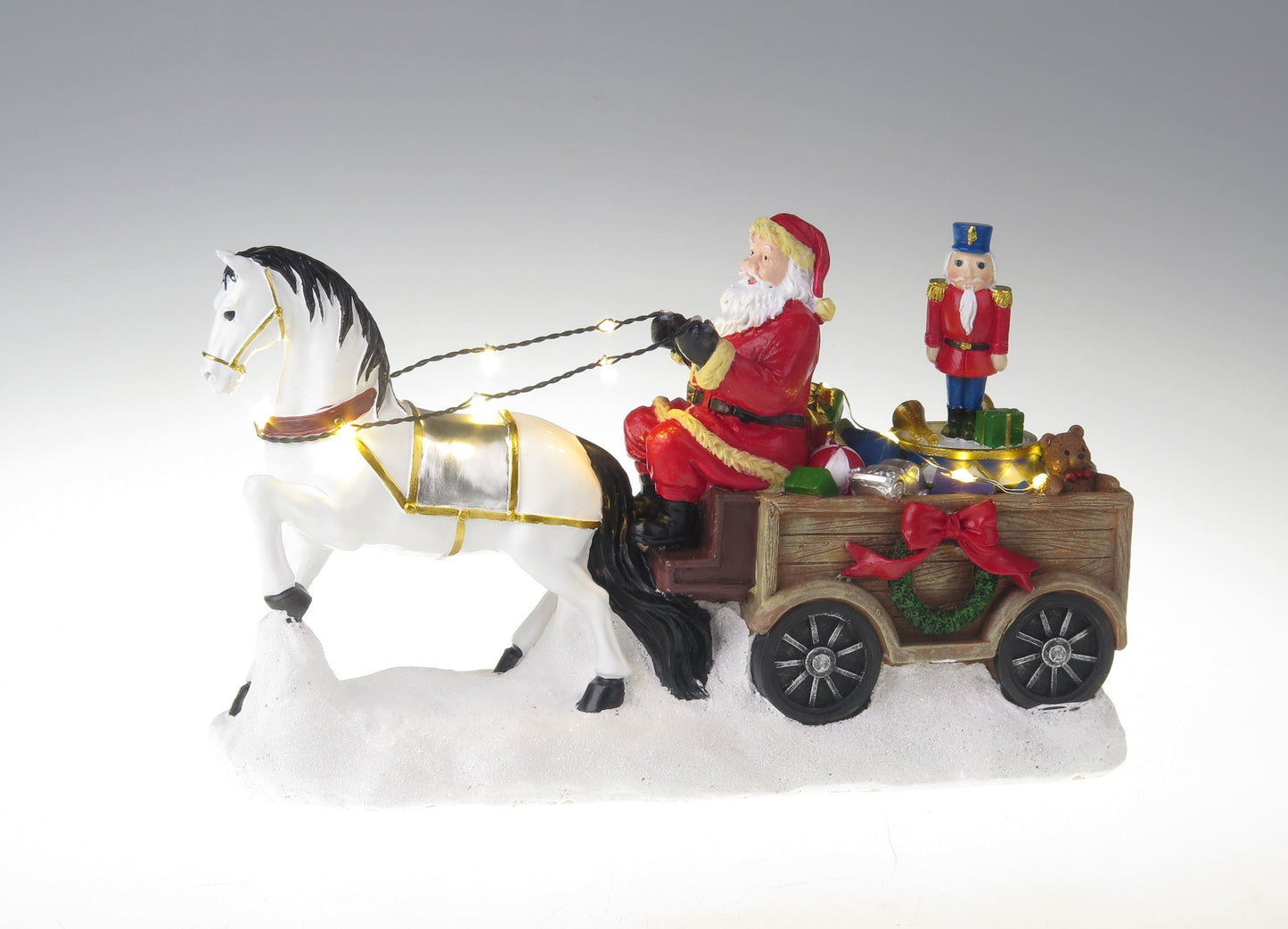 Kerstman met wit paard, wagen en rotatienotenkraker