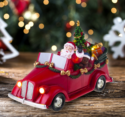 Père Noël en voiture avec arbre tournant