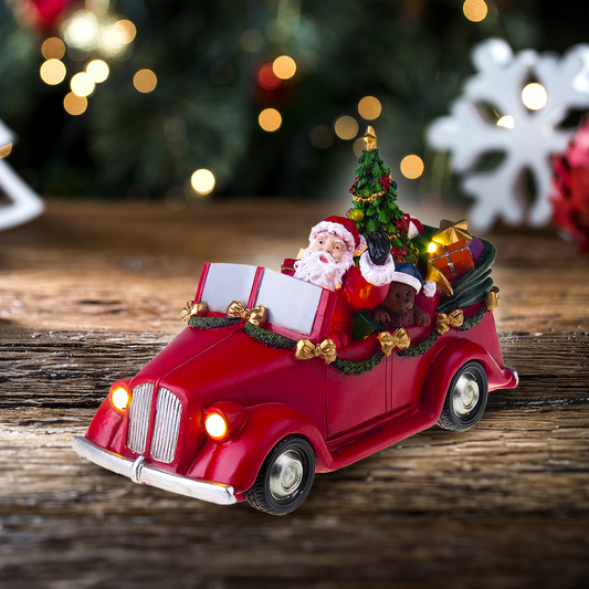 Kerstman in auto met draaiende boom